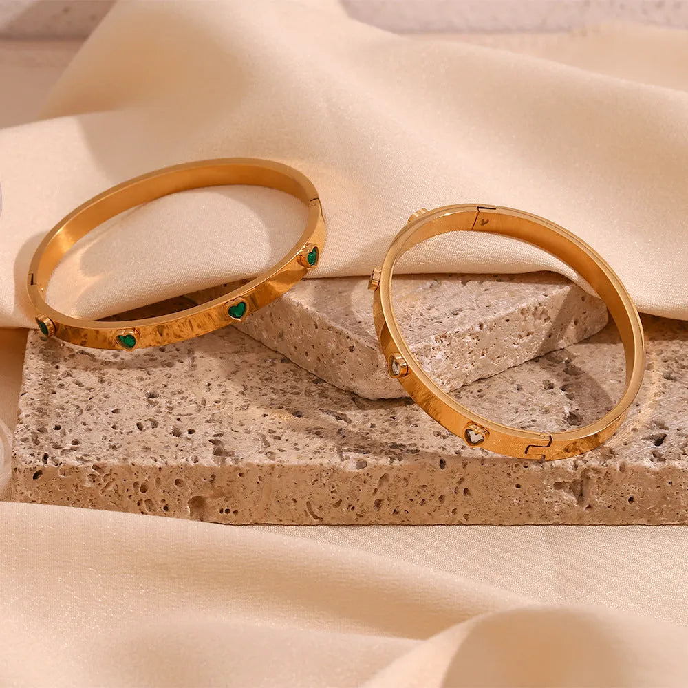 Stainless steel bracelet with peach heart centrepiece and micro-inlaid detailing in golden finish