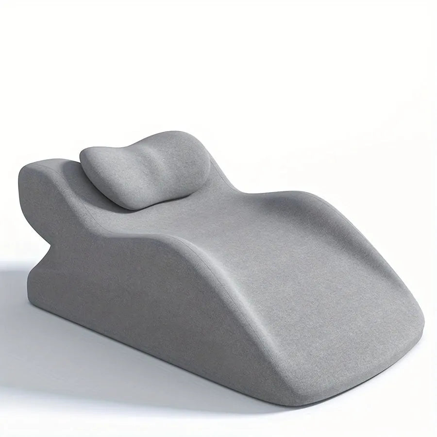 A stomach sleeper pillow in blue, designed for prone positioning and reading in bed.