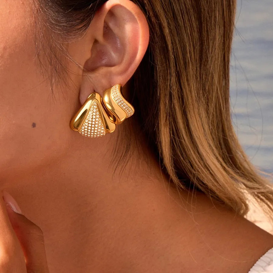 Gold triangle stainless steel geometric stud earrings with electroplated finish on white background