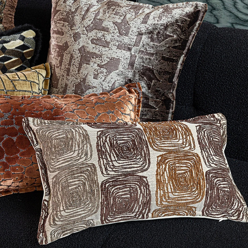 Cream and coffee-coloured abstract coil pattern on a square decorative pillow cover.