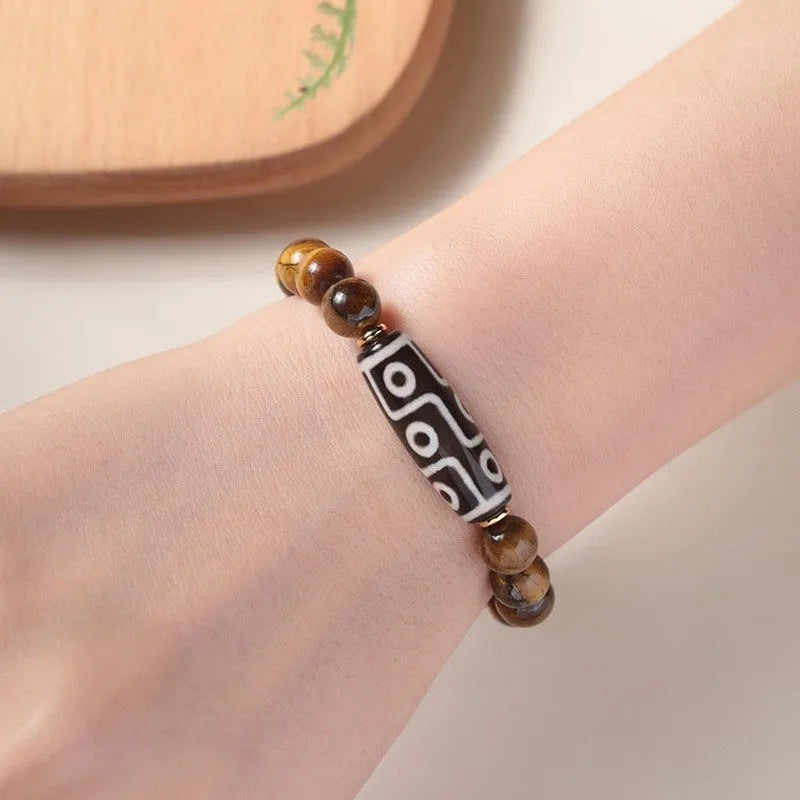 Ethnic style tigereye Dzi bead simplicity Buddha rosary bracelet on display with multiple bead sizes