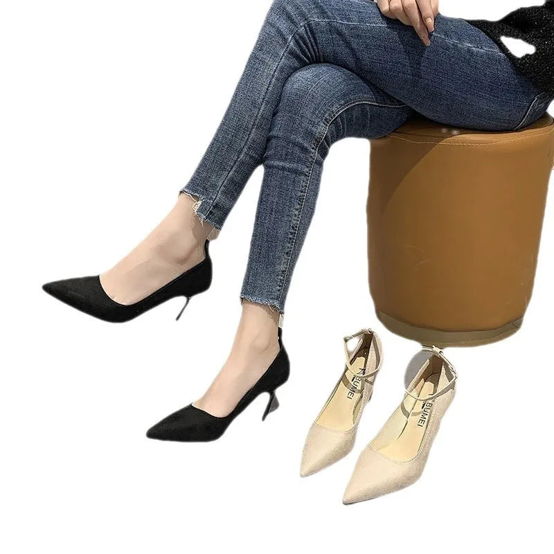 Women's black stiletto heel pumps with buckle detail showing 8cm rubber sole