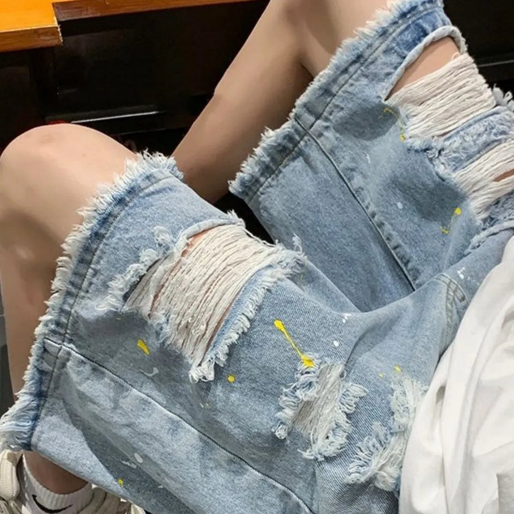 Men's distressed denim shorts with holes in light blue colour, loose fit above knee length