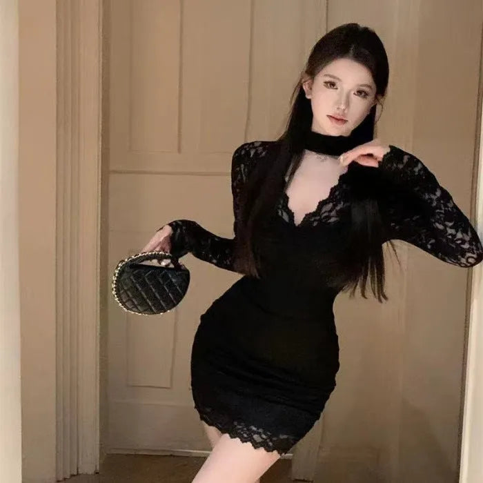 Women's black halter neck lace dress with wrap-effect hip detail and inner skirt, floral pattern, A-line silhouette.