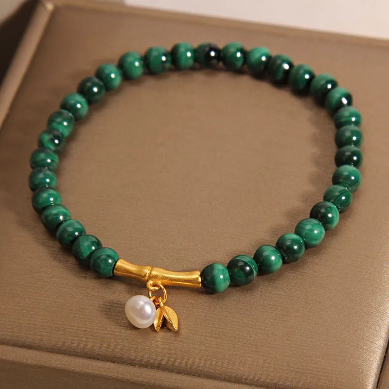 Women's white crystal lucky bamboo bracelet on display