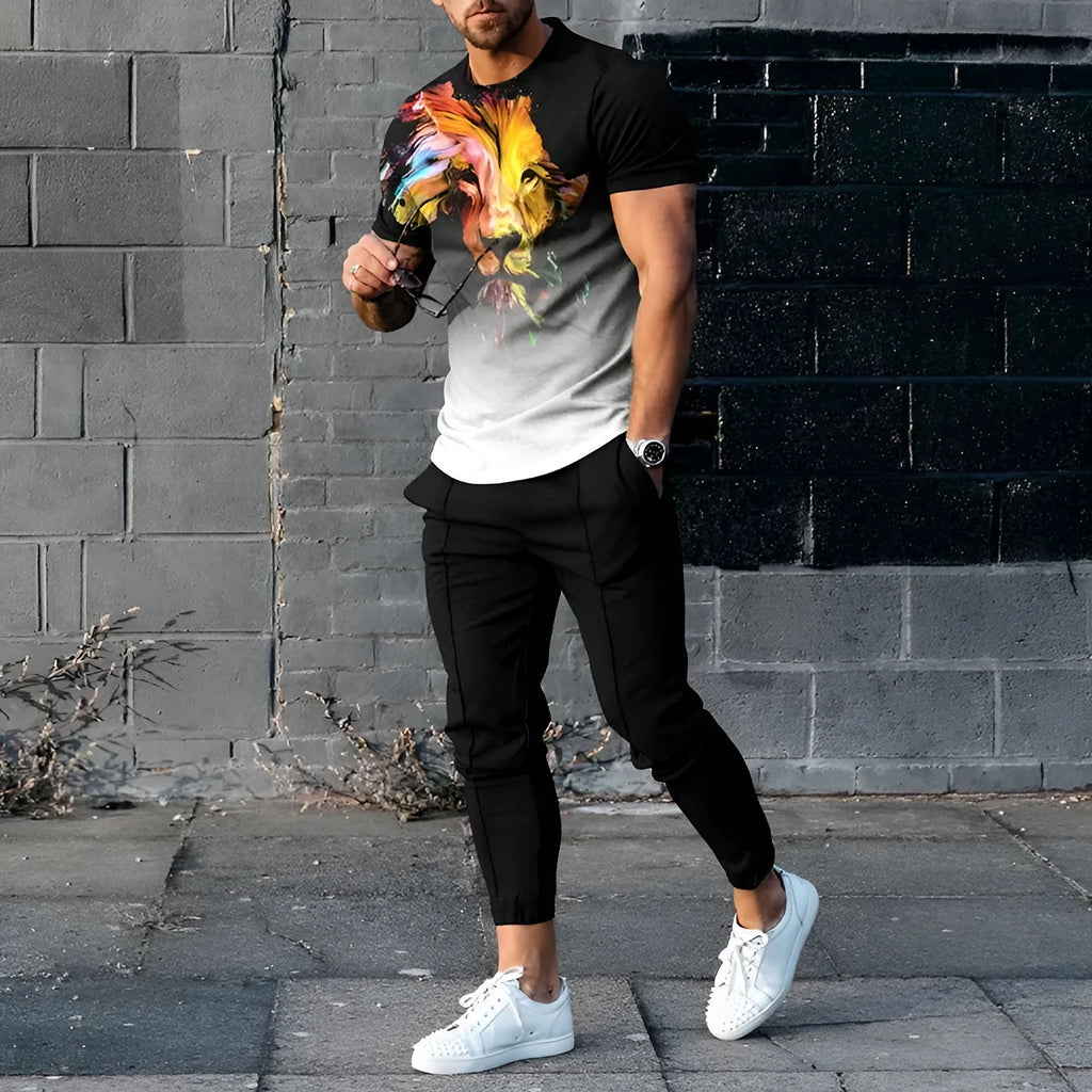 Man wearing a light grey short-sleeved pullover and matching trousers from a men's two-piece tracksuit set.