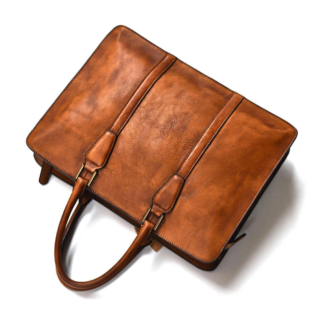 Men's brown leather retro handbag with horizontal square shape and zipper opening.