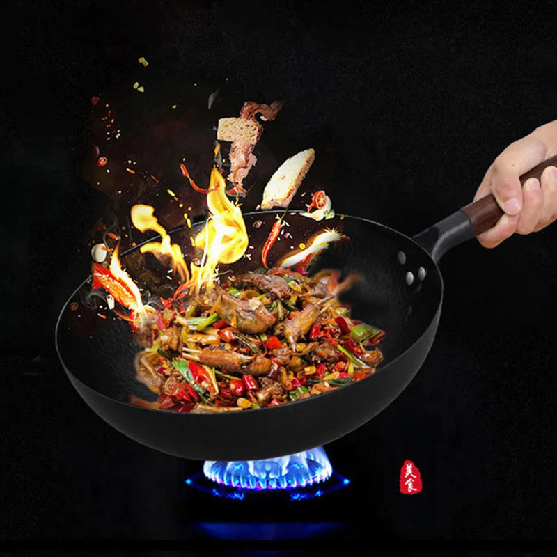 Traditional handmade iron wok pan with wooden handle and black finish