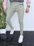 Man wearing slim-fit plaid casual trousers with a straight leg and micro-elastic fabric.