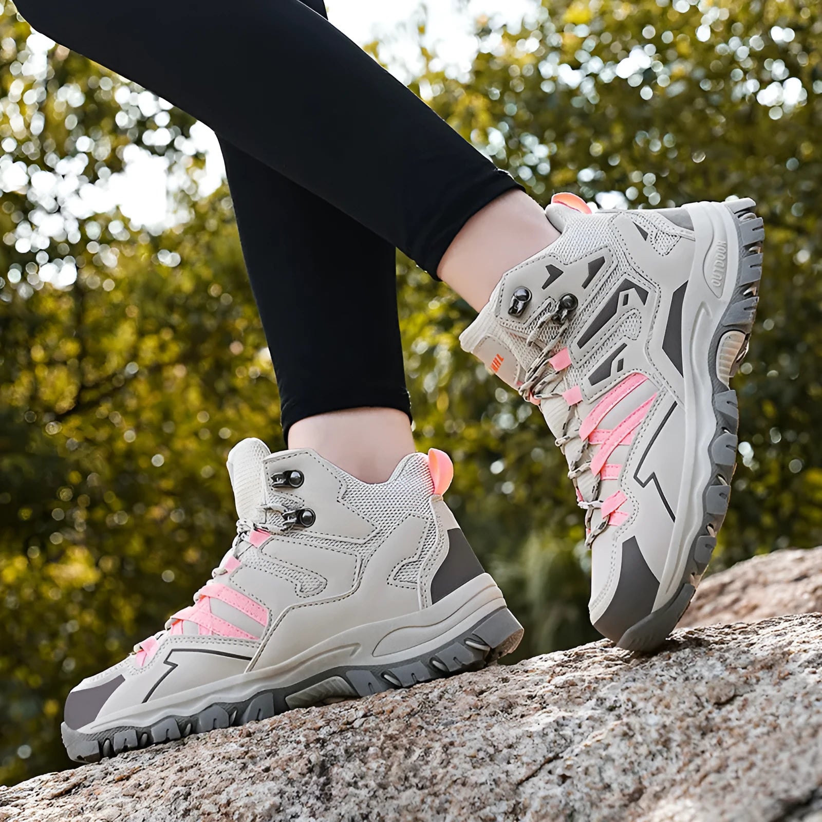Flannel upper hiking sneakers with rubber soles in light brown colour on a rocky path.
