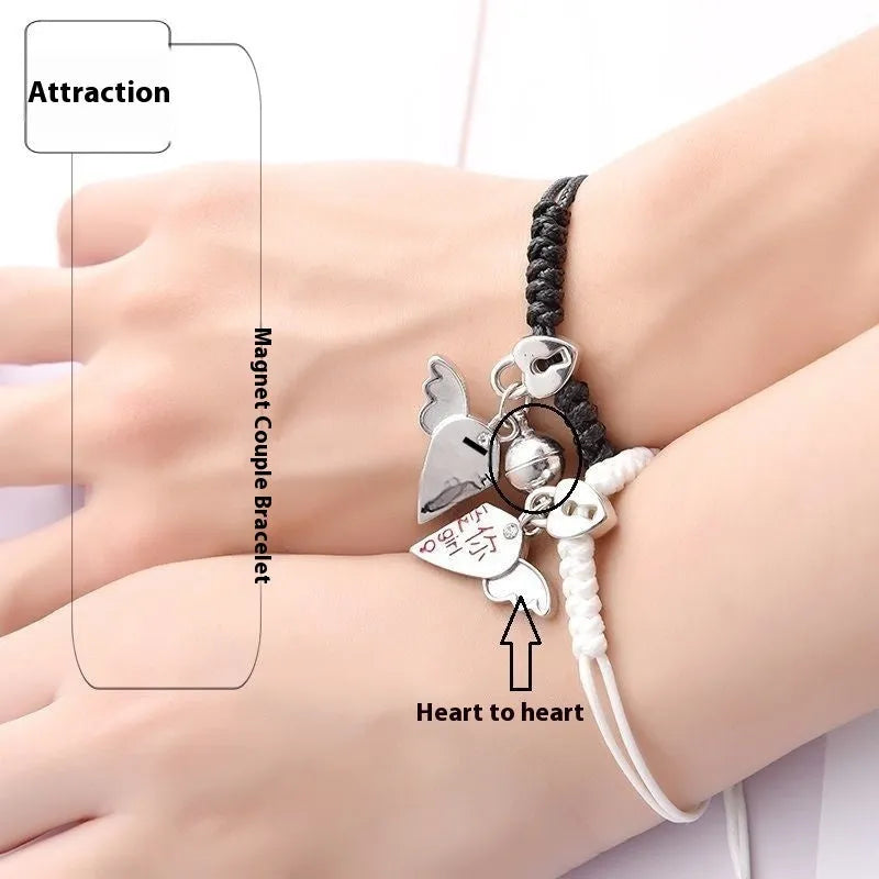 A pair of silver alloy bracelets with magnetic clasps and assorted charm designs including crowns, stars, and clovers.