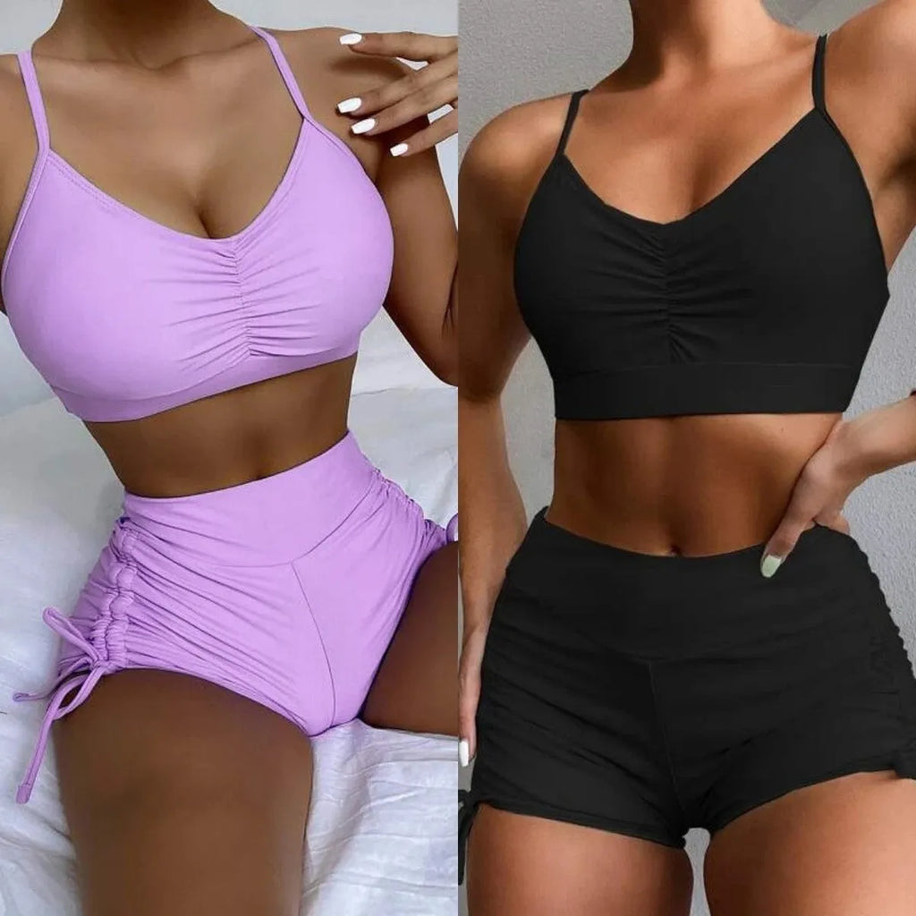 Women's high-waist split bikini swimsuit in solid black and purple colours showing two-piece design
