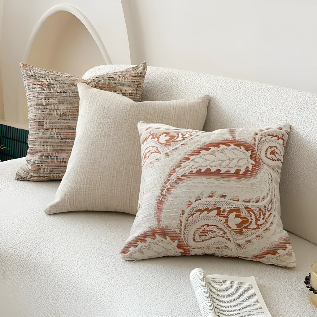American-style amber jacquard pillow cover with paisley plant pattern, shown on a sofa.