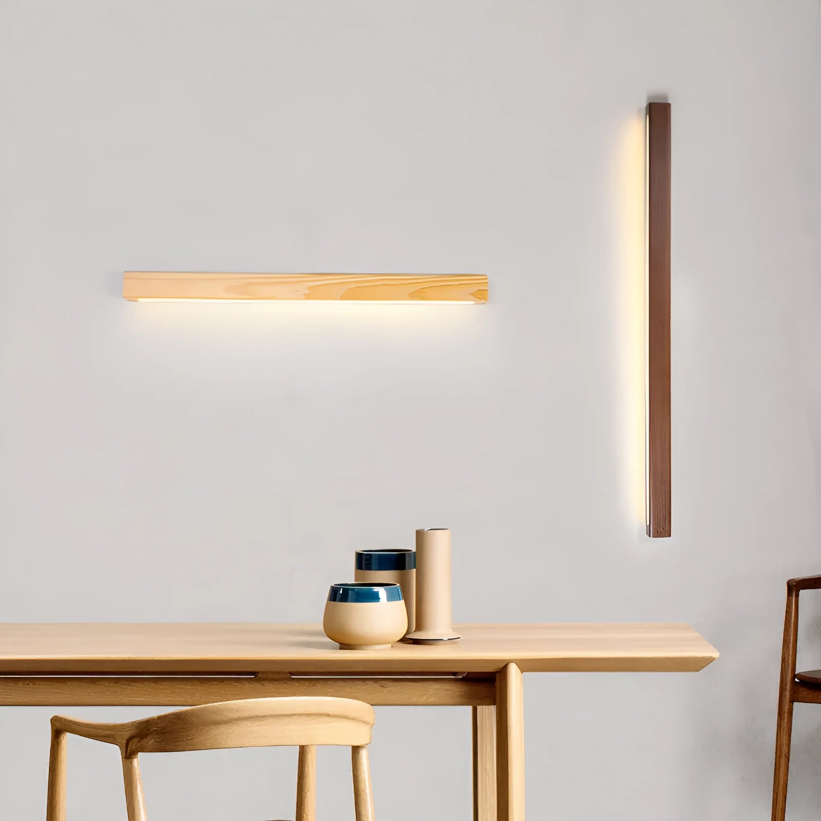 Slim walnut-colour wood and acrylic LED strip wall lamp in three length options on a white wall.