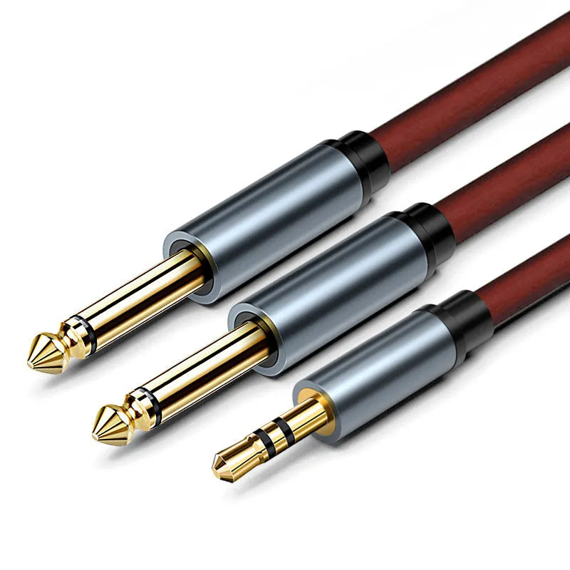 3.5mm to two 6.5mm male audio cable with gold-plated connectors on a black background