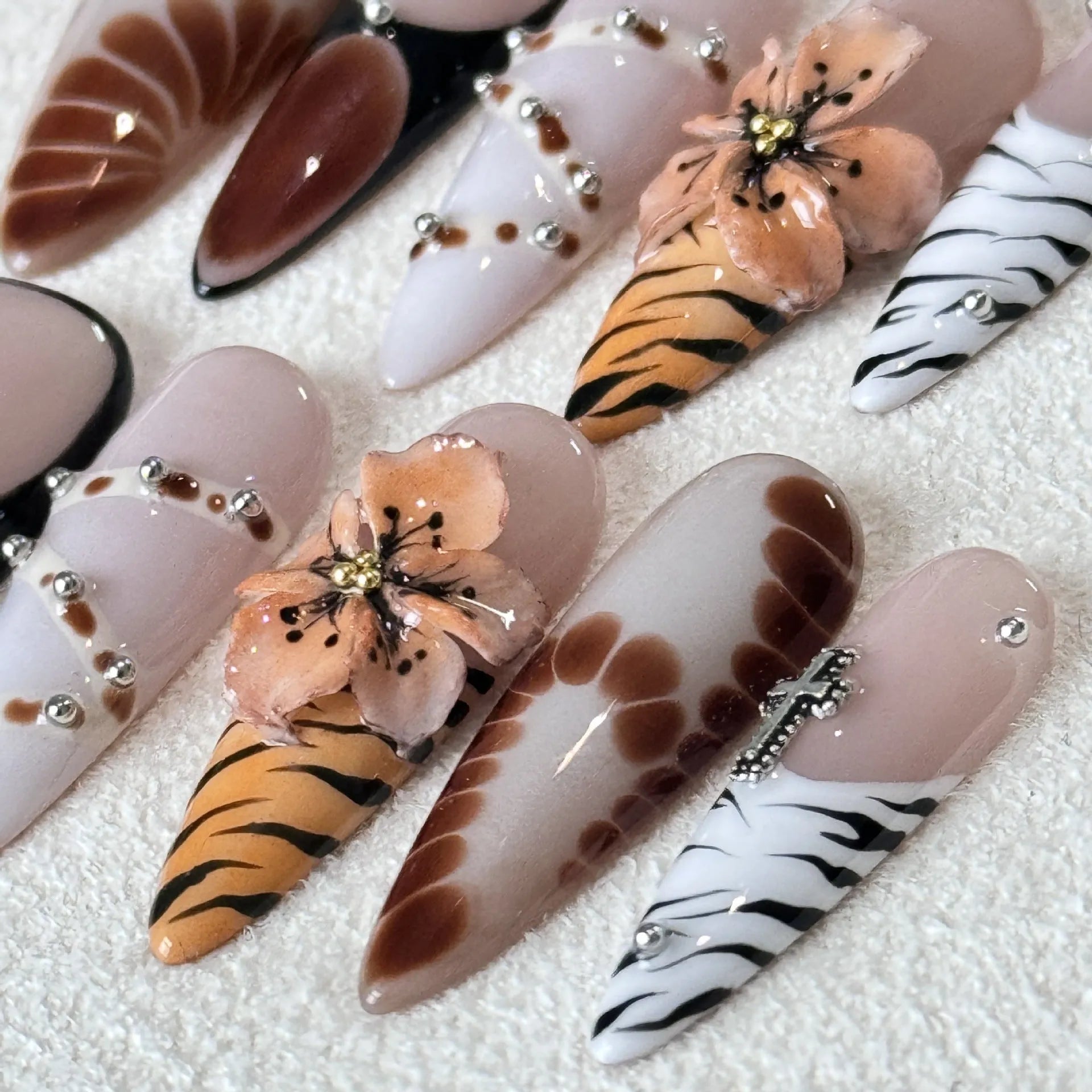 Handmade leopard, cross, and flower print nail stickers in four sizes on a backing card.