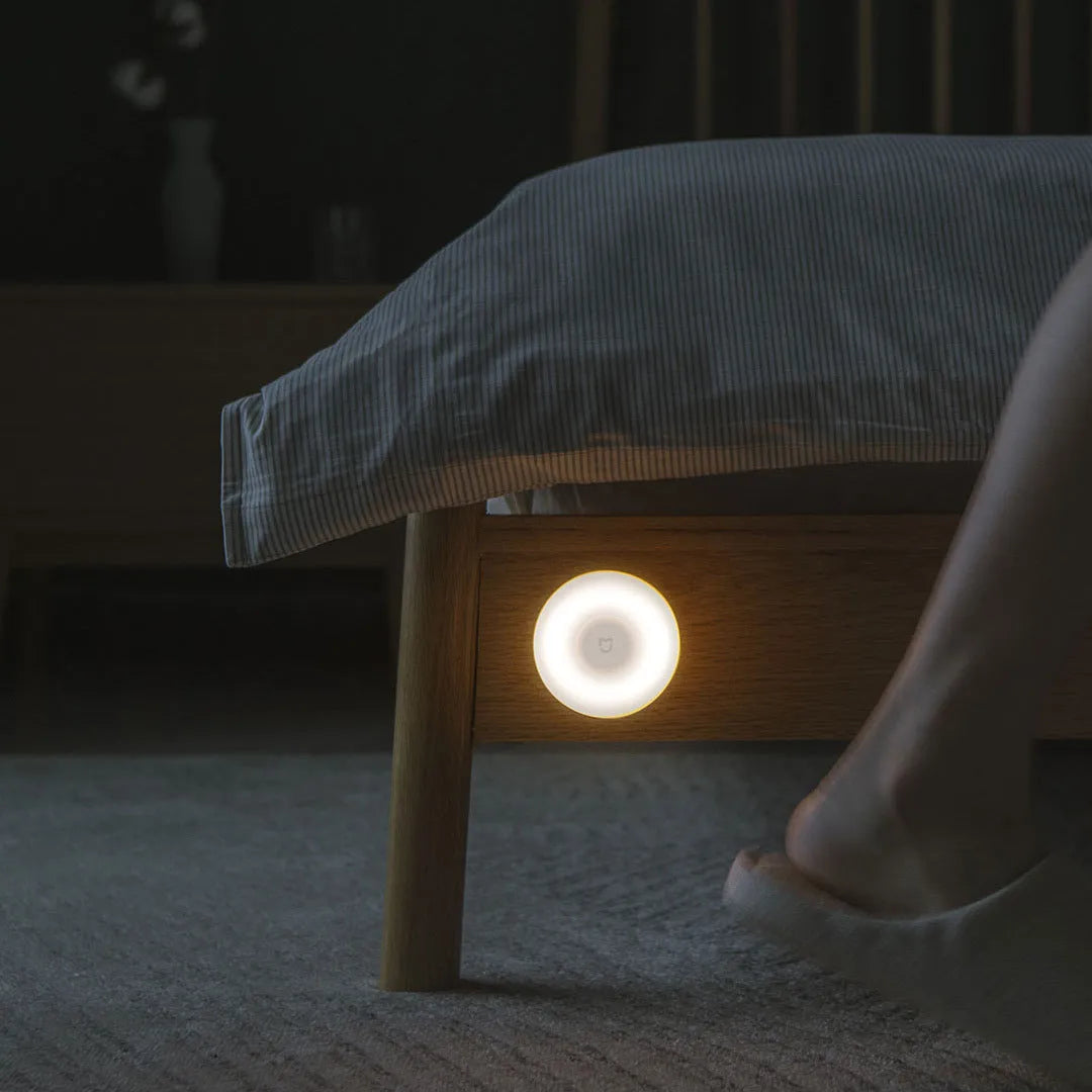 White modern bedside table lamp with human body induction and Bluetooth connectivity.