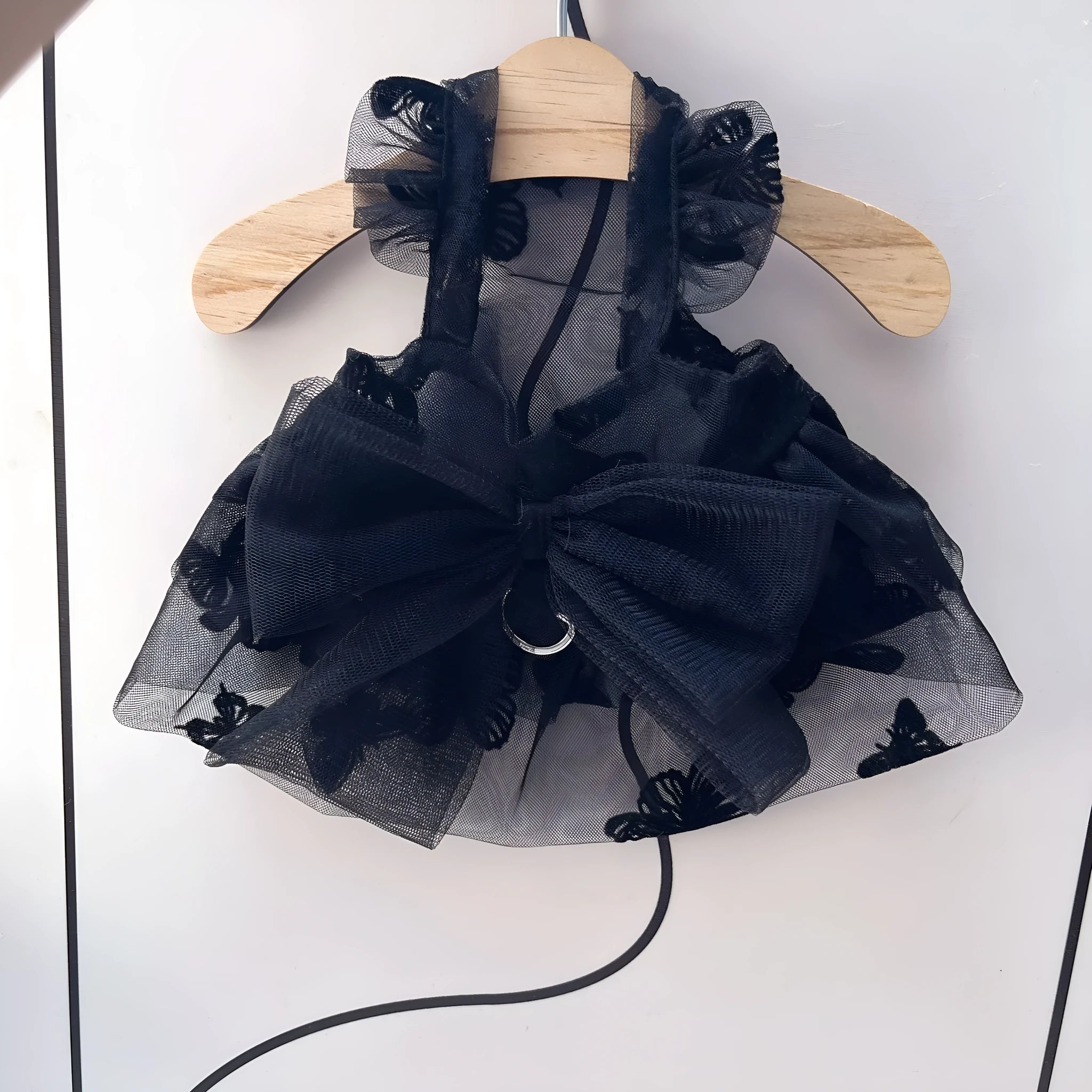 Black tulle princess skirt costume on small dog, showing tiered gauze design and adjustable fit.