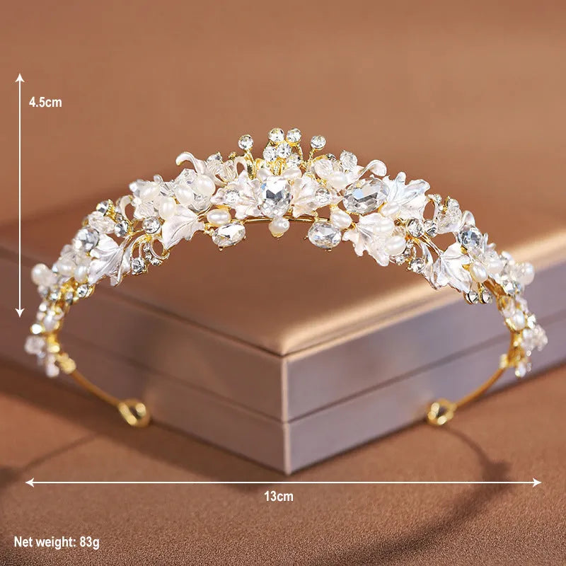 Gold metal alloy crown headdress with a white pearl-like decoration for women.
