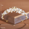 Gold metal alloy crown headdress with a white pearl-like decoration for women.