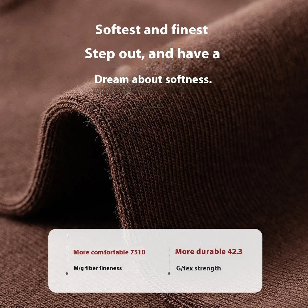 Pack of men's solid colour mid-calf business socks in combed cotton on a neutral background.