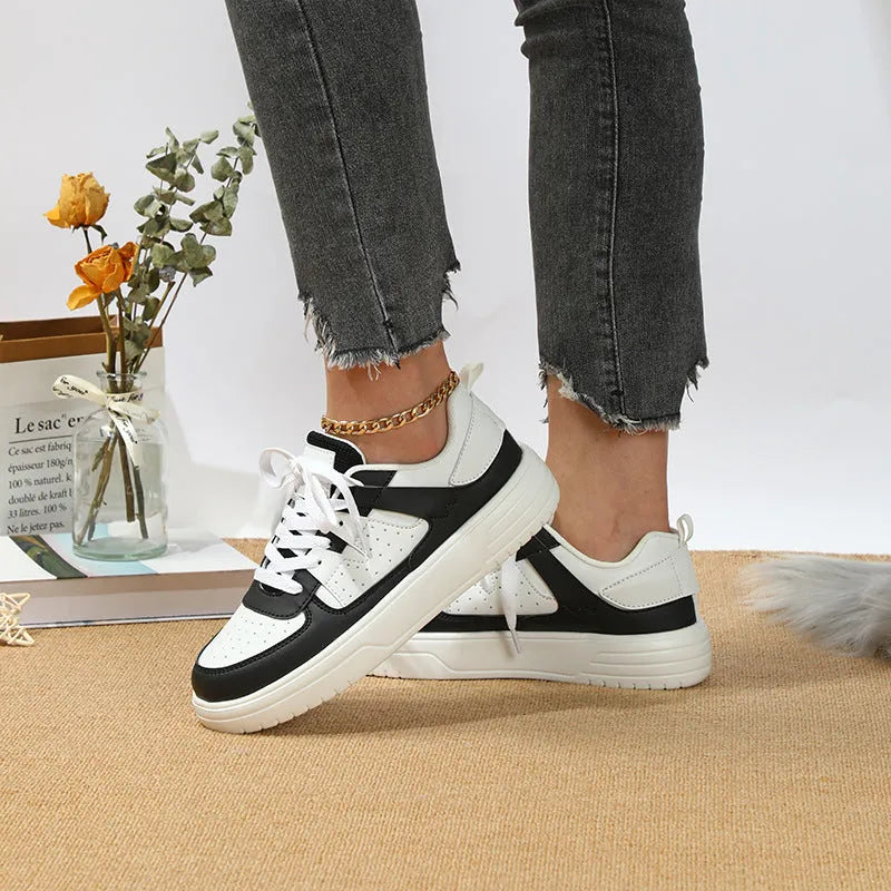 Casual solid colour low top sports shoes with front lace-up, round toe, and metal accents on a white background