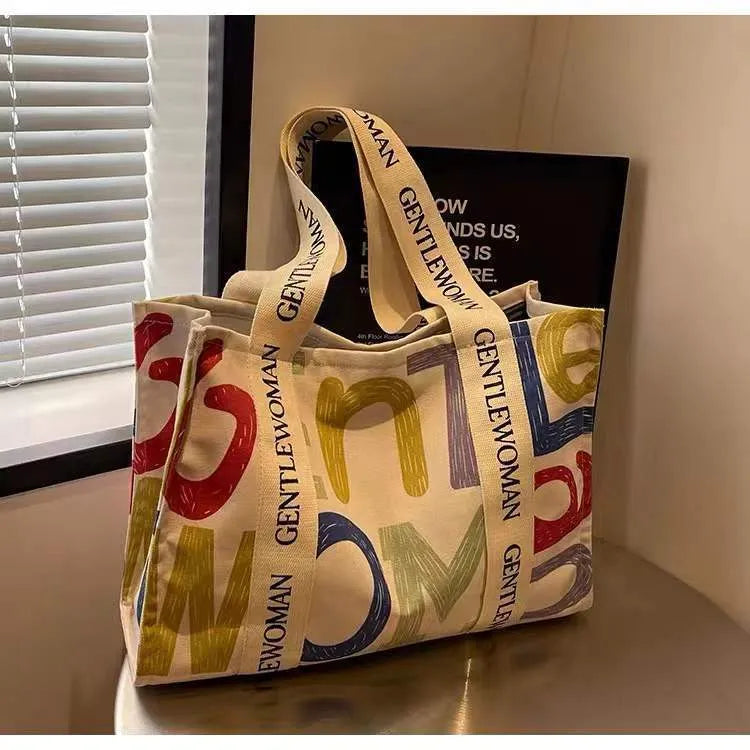 Canvas women's travel tote shopping bag with printed design in unisex style