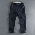 Men's dark blue cotton work trousers with flat front design and straight leg.