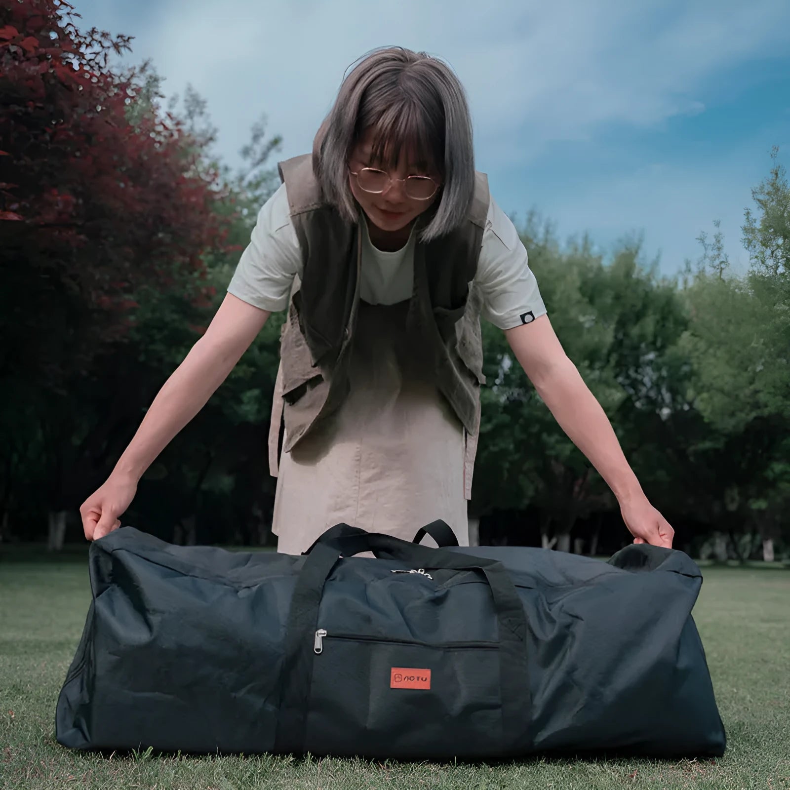 Large black waterproof storage bag for camping tents and folding chairs, shown with size dimensions.