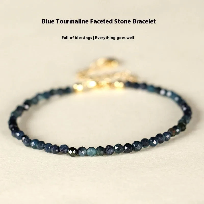 Close-up of a women's blue tourmaline bracelet with 3mm cut beads and spacer bead design.