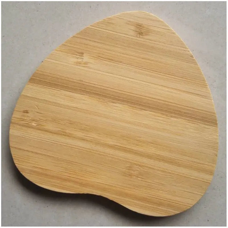 Brown heart-shaped wooden bamboo wireless charger on a table