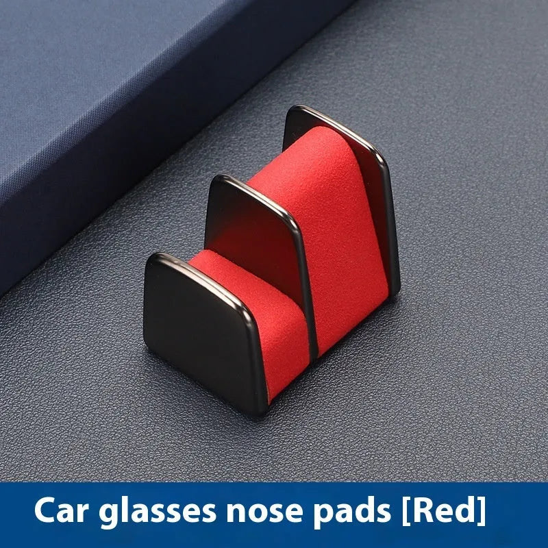Zinc alloy car dashboard glasses holder in four colours measuring 3.7x3.2x2.5 cm