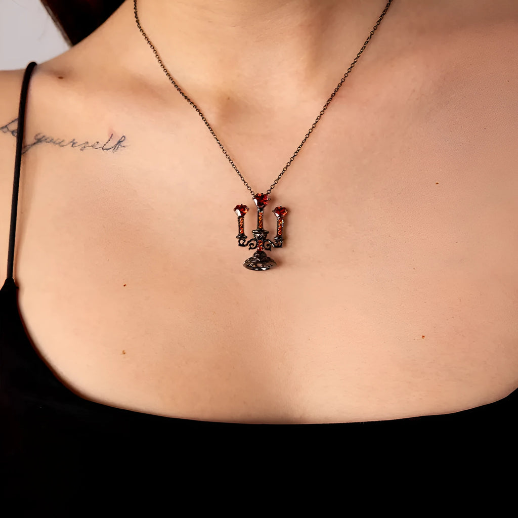 Close-up of a women's zinc alloy Gothic necklace with a hollow retro candlestick pendant on a cross chain.