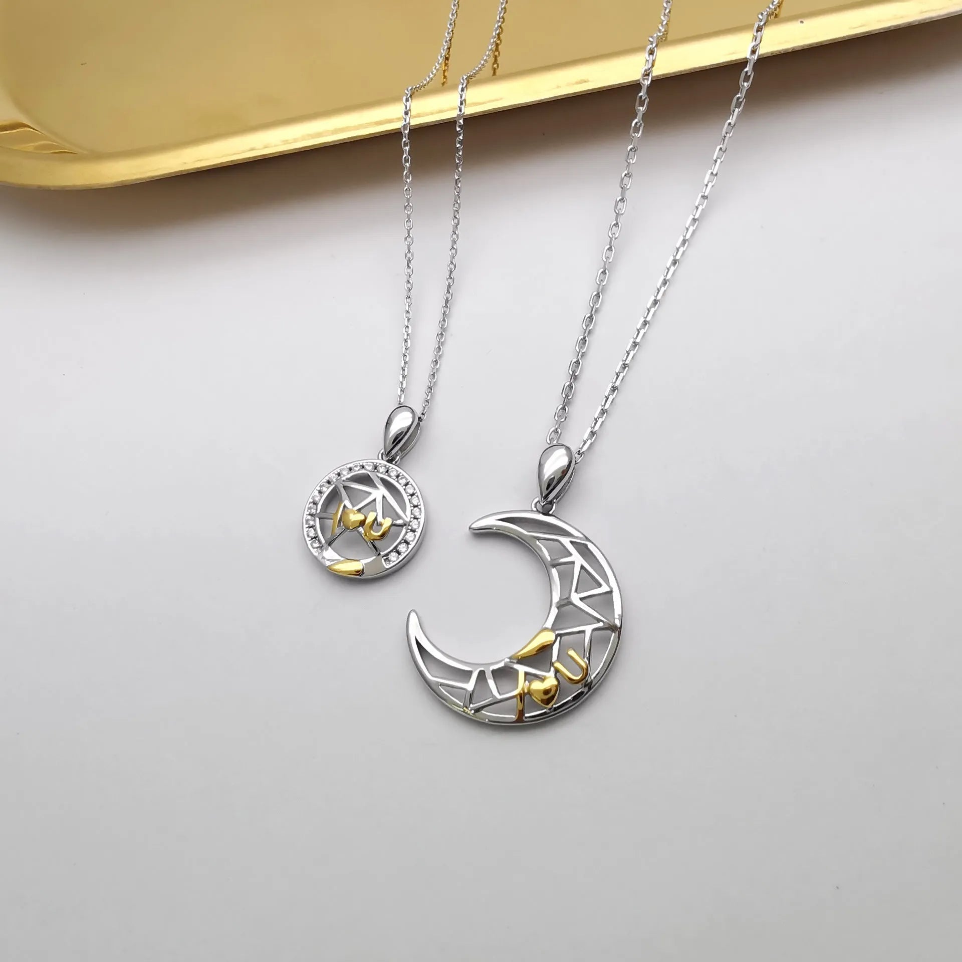 Copper sun and moon tooth couple necklace with electroplated finish on cross chain.