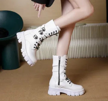 Black mid-calf women's boots with a prominent buckle detail and side zipper on a white background.