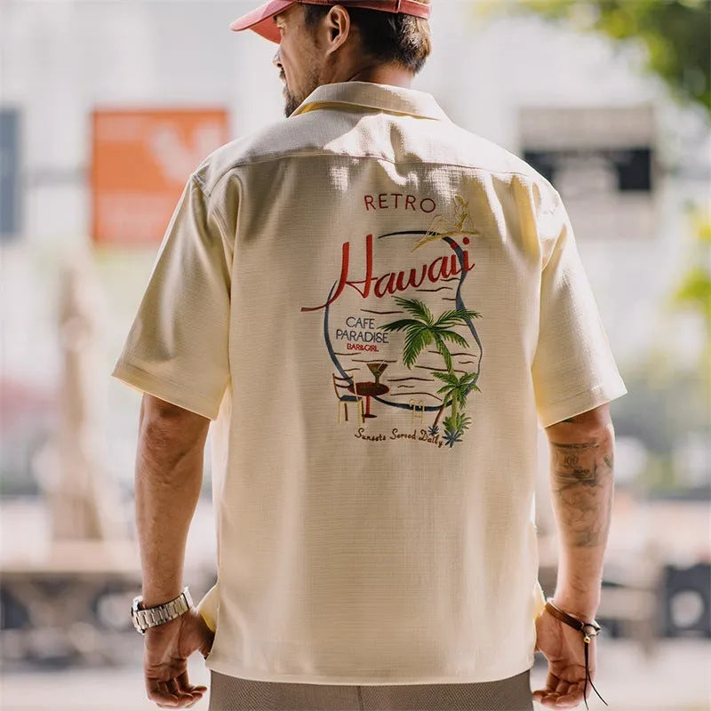 Light apricot men's shirt with bamboo print and a Cuban collar laid flat.