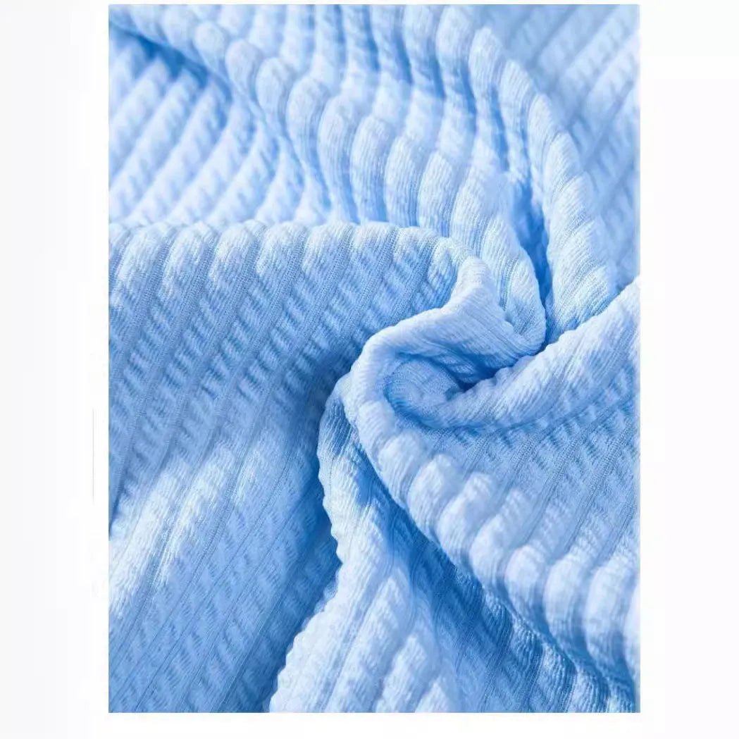 A loose-fitting men's short sleeve casual shirt in a light blue colour, laid flat.