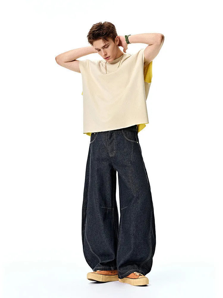 Men's wide leg cotton denim trousers in original cow colour, shown laid flat.