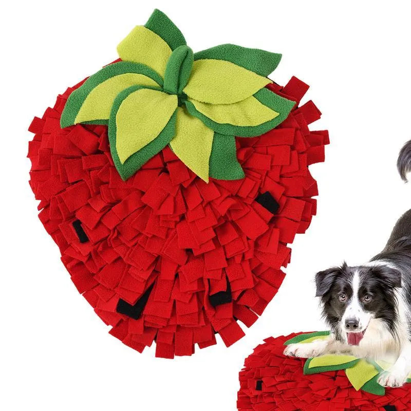 Red and green strawberry-shaped pet sniffing mat for dogs and cats on a wooden floor