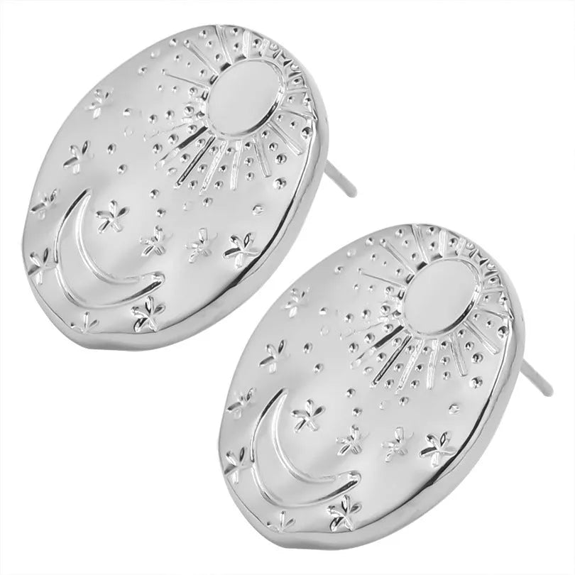 A pair of geometric stainless steel earrings with a small shell detail, shown in gold and silver finish options.