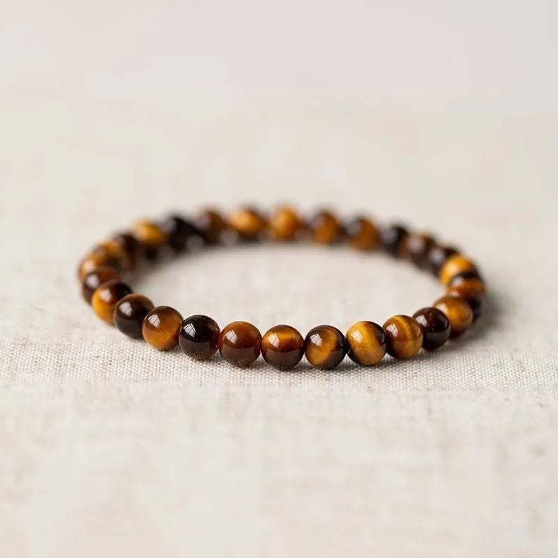 Ethnic style tigereye Dzi bead simplicity Buddha rosary bracelet on display with multiple bead sizes