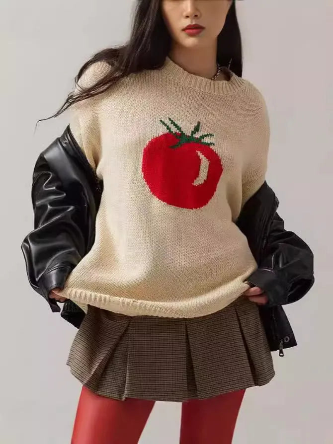 Women's loose-fitting beige jacquard knit sweater on a hanger, showing round neck and long sleeves.