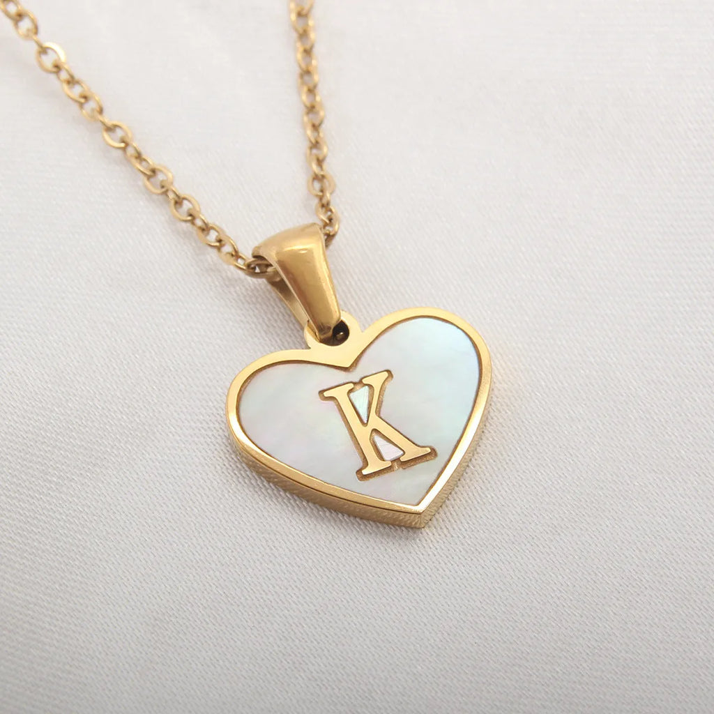 Gold heart-shaped white shell necklace with personalised letter charm on adjustable chain