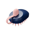 Soft silicone handheld pet hair remover and massage brush in dark blue on a white background.