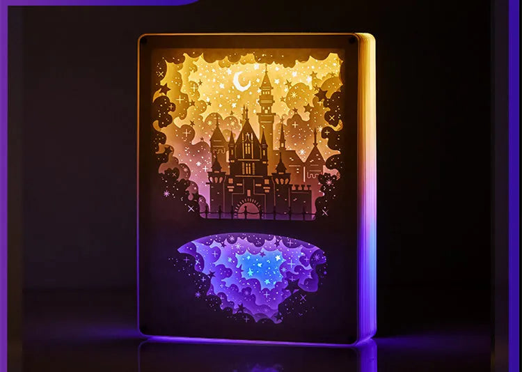 USB-powered bedside night light with three-dimensional paper carving design in yellow or purple light