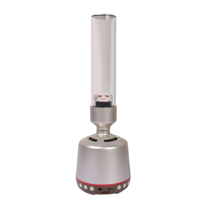 White silver candlelight Bluetooth speaker and night light on a table, showing modern cylindrical design.