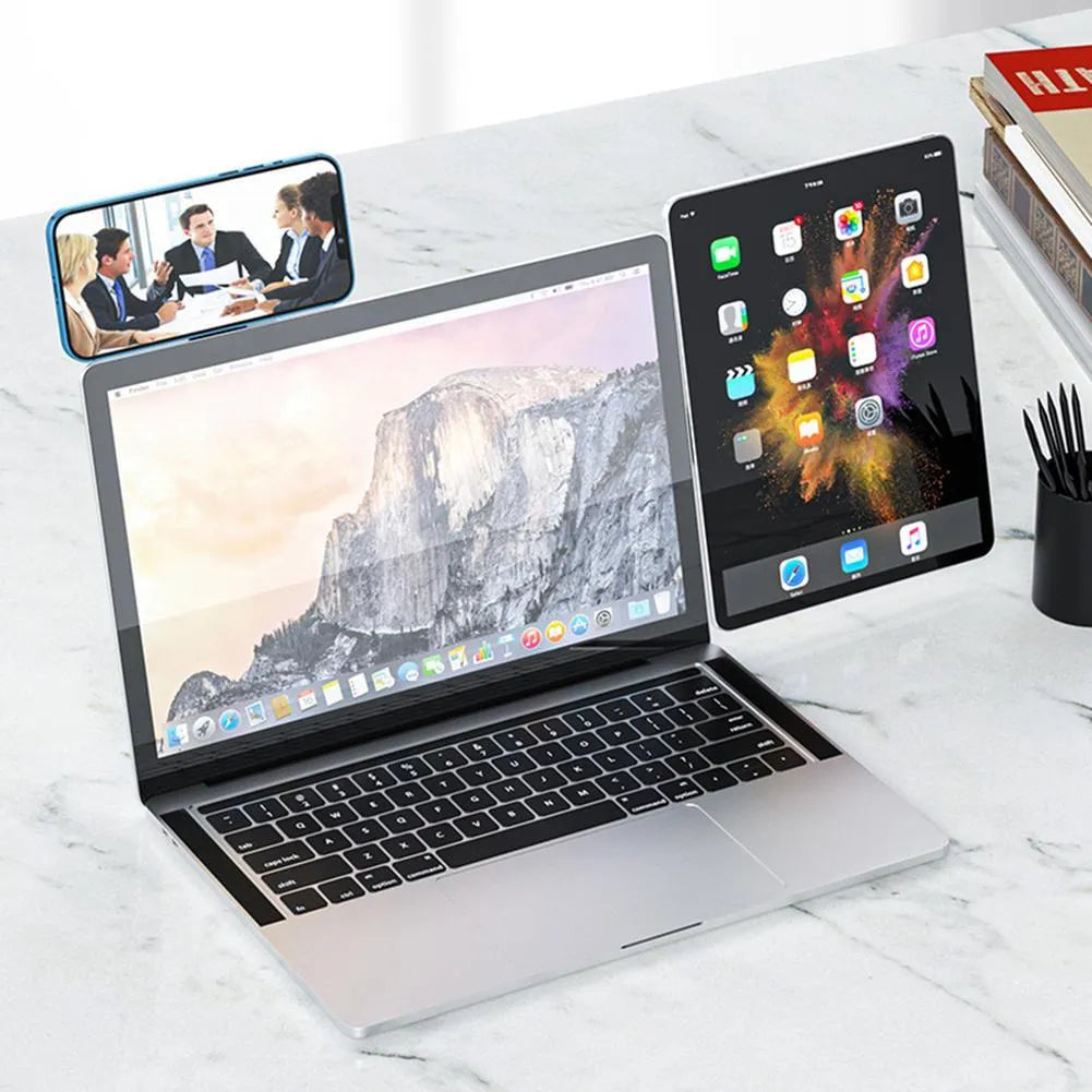 Black aluminium laptop phone holder with magnetic mount attached to laptop side