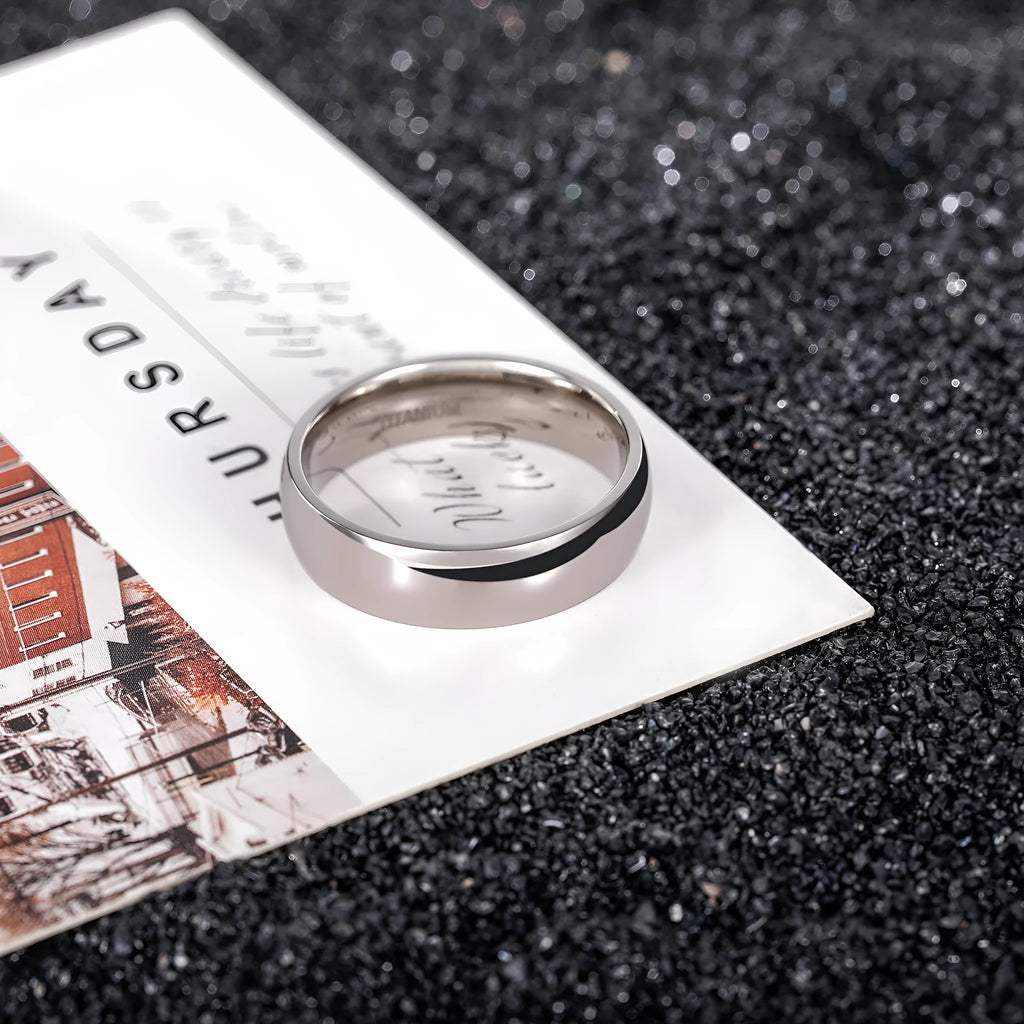 Silver-coloured plain titanium band ring shown in three different widths: 2mm, 4mm, and 6mm.