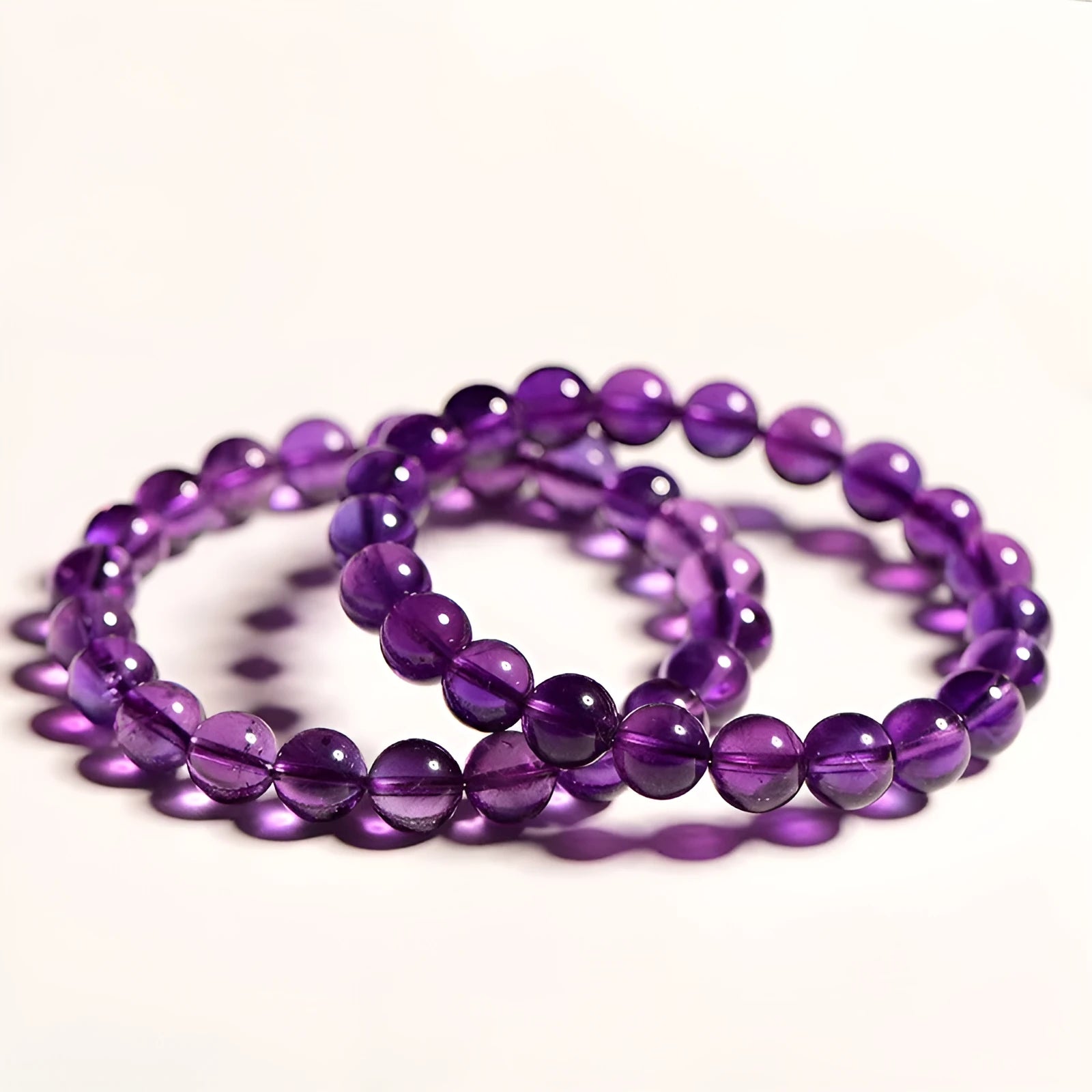 Natural Uruguay amethyst bracelet with scattered beads in four colour grades and eleven size options