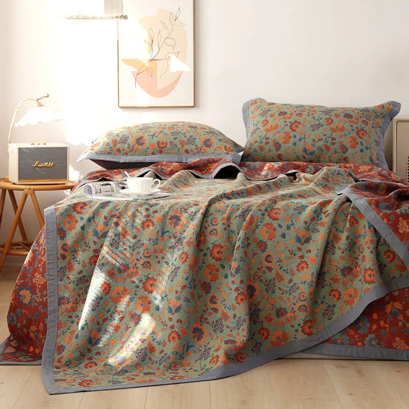 Cotton gauze three-piece bedding set with botanical flower pattern showing blanket and two matching pillowcases